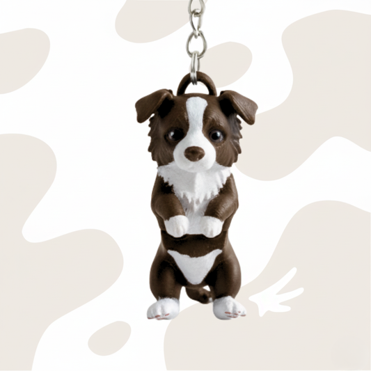 Brelok w kształcie psa rasy Border Collie, brązowo-biały, wykonany z ekologicznego materiału PLA, zawieszony na łańcuszku